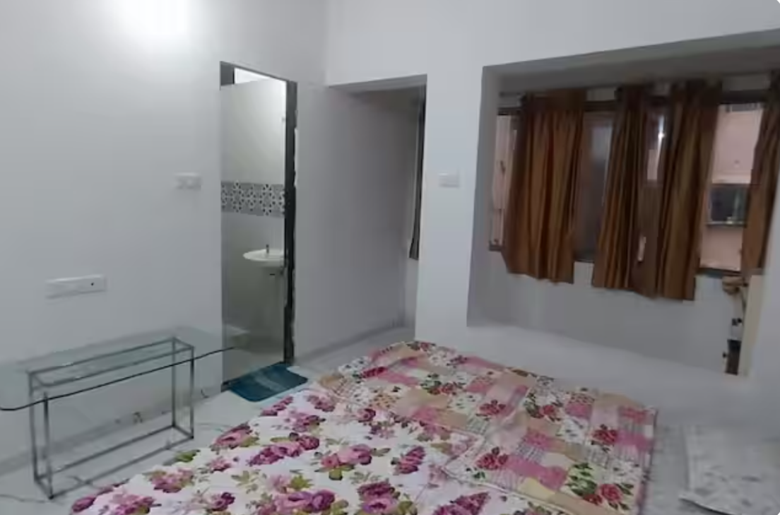 Bright bedroom with attached bathroom and large windows at AG House